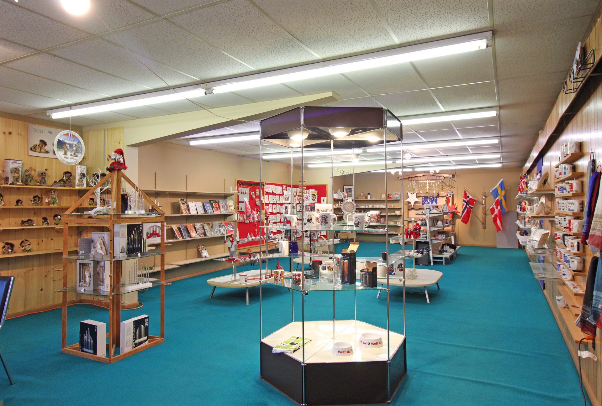 a large store with a blue carpet and lots of shelves