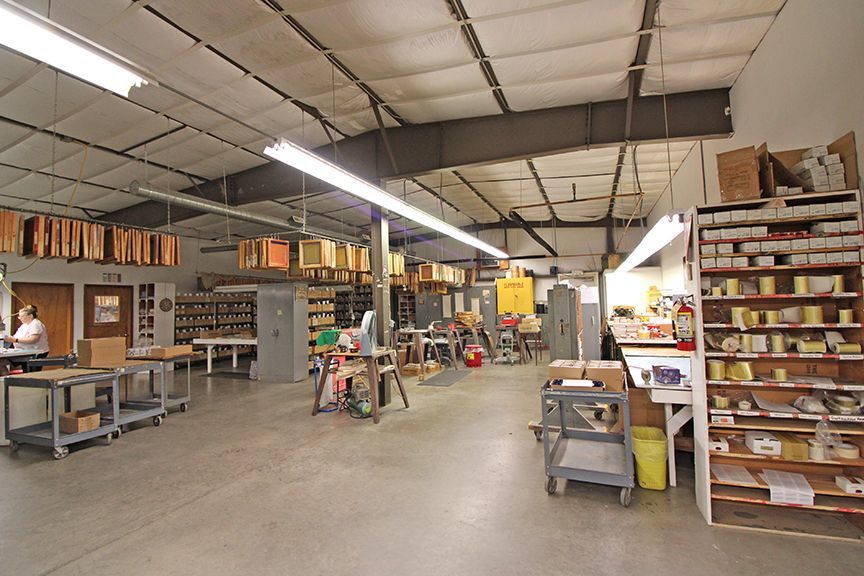 a large warehouse with lots of shelves and tables