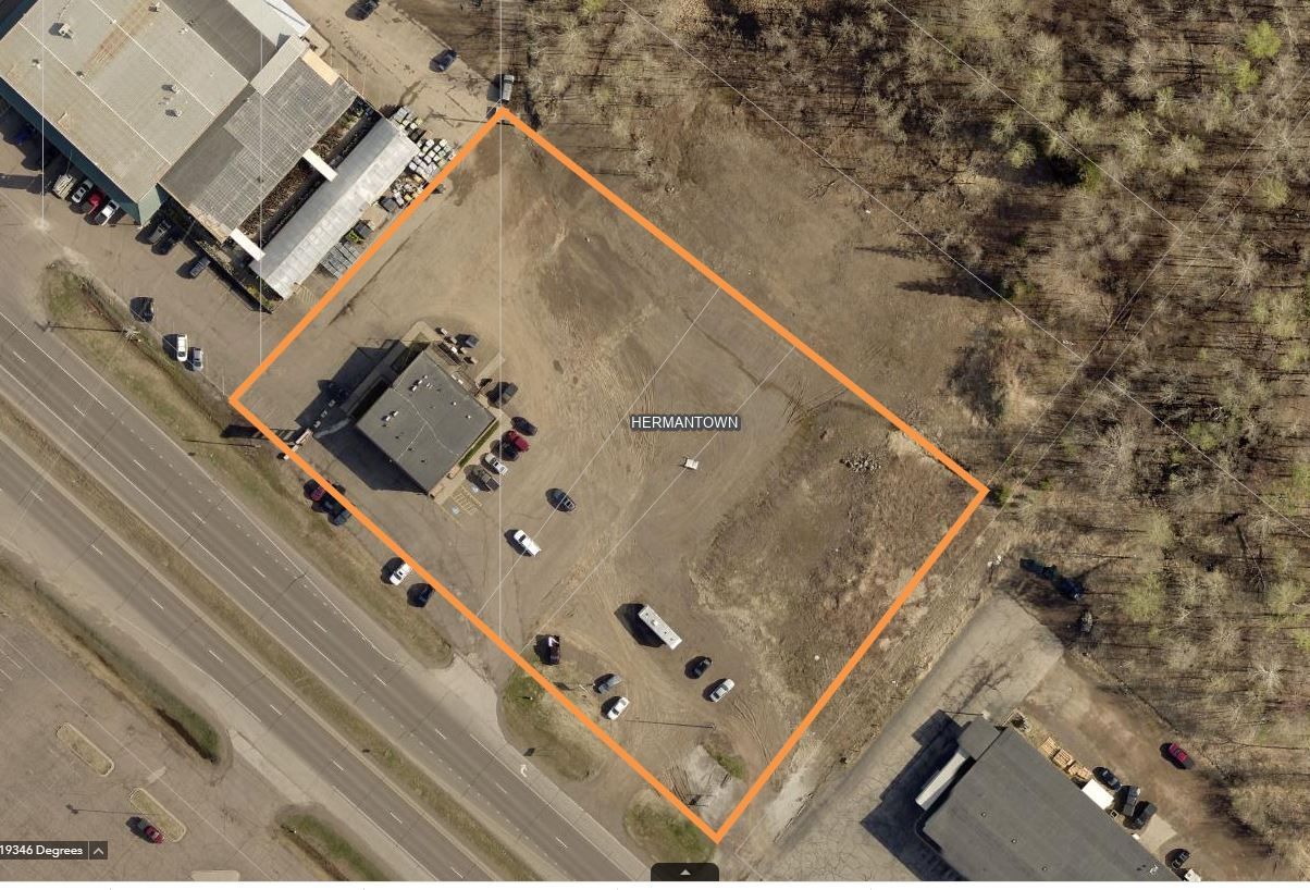 an aerial view of a building and a parking lot