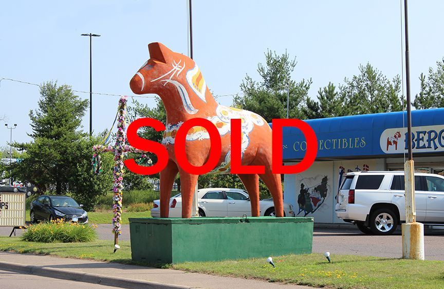 a statue of a horse in front of a collectibles store