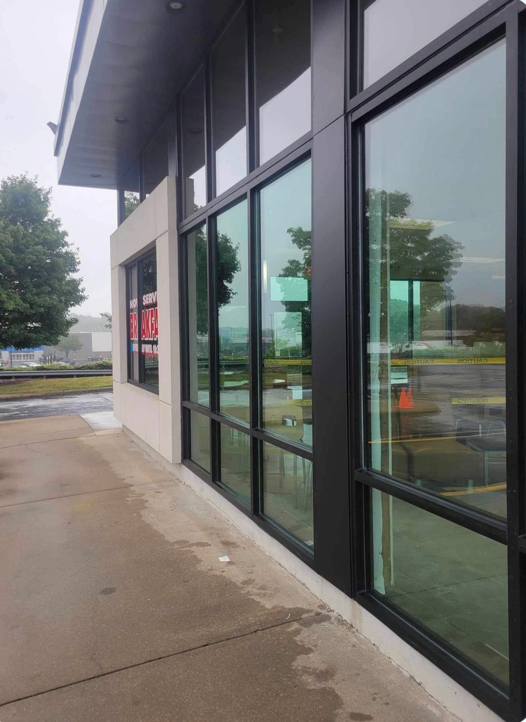 a building with a lot of windows and a tree in the background