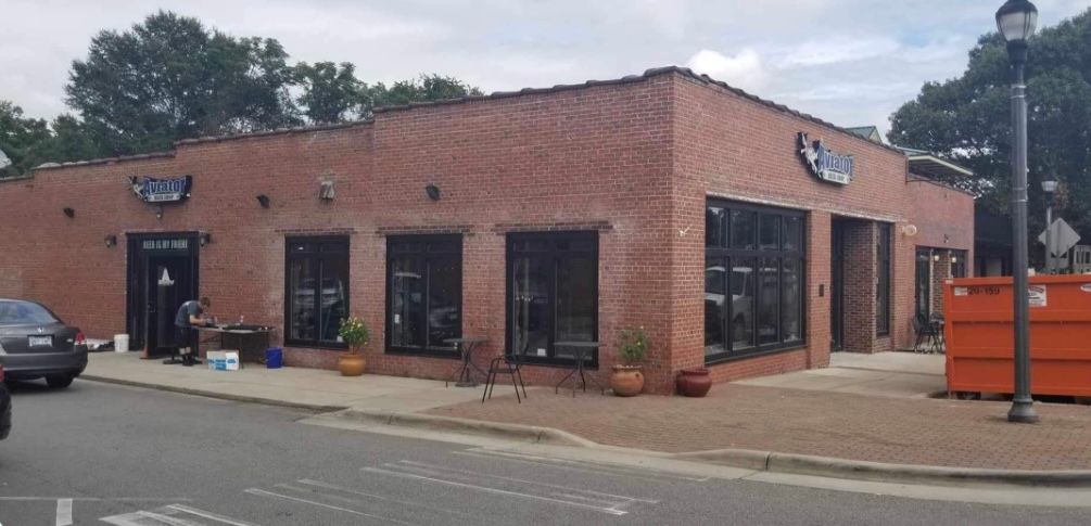 a brick building with a car parked in front of it