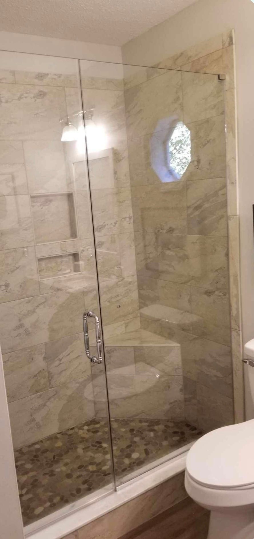 a bathroom with a walk in shower and a toilet