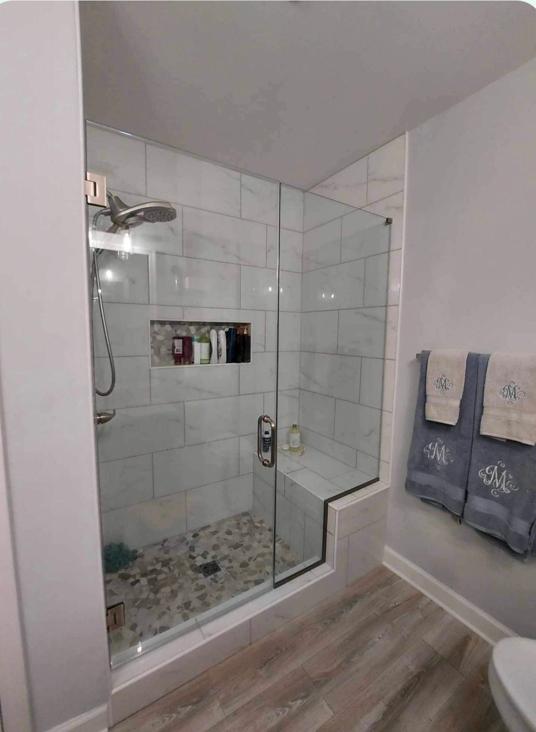 a bathroom with a walk in shower and a toilet
