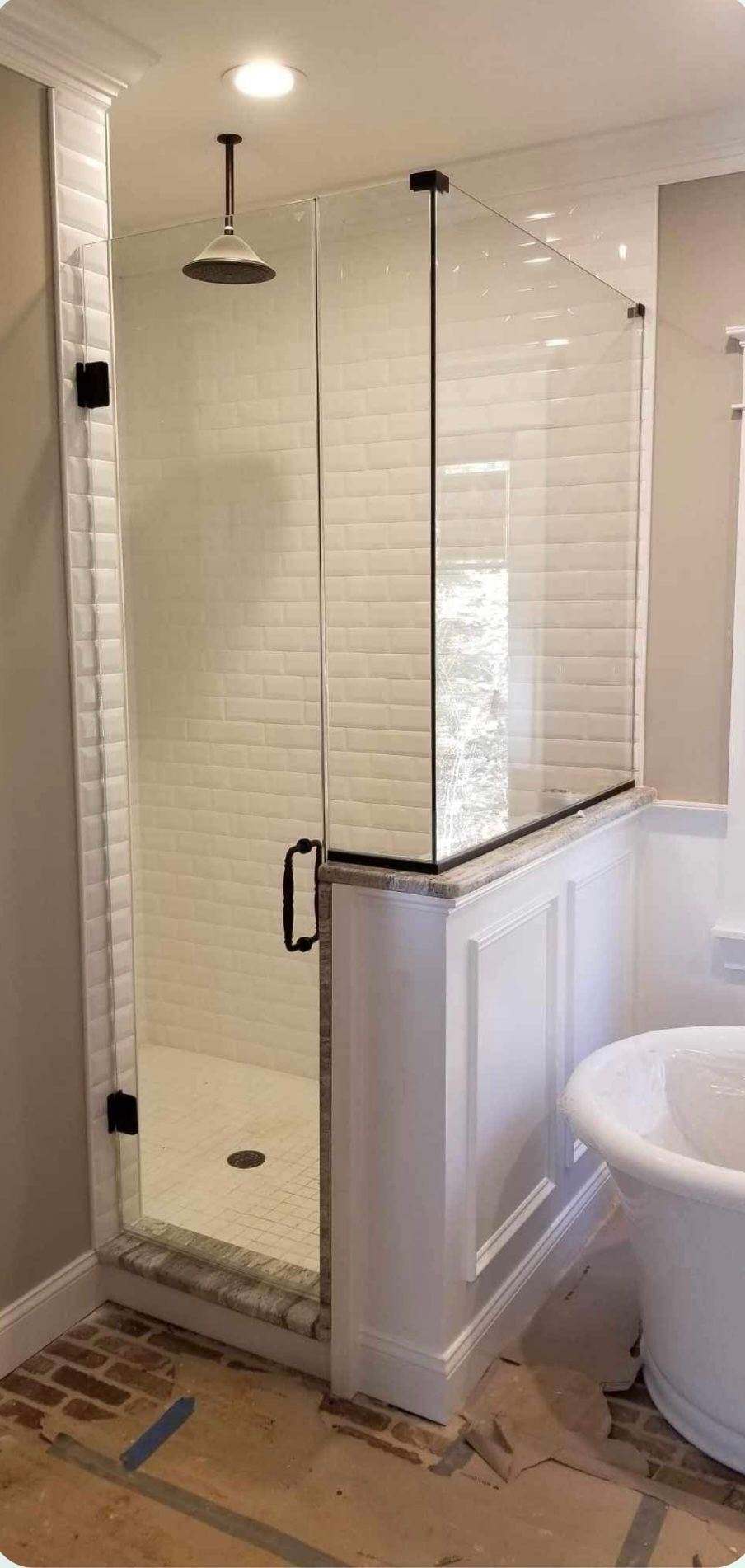 a bathroom with a walk in shower and a bathtub