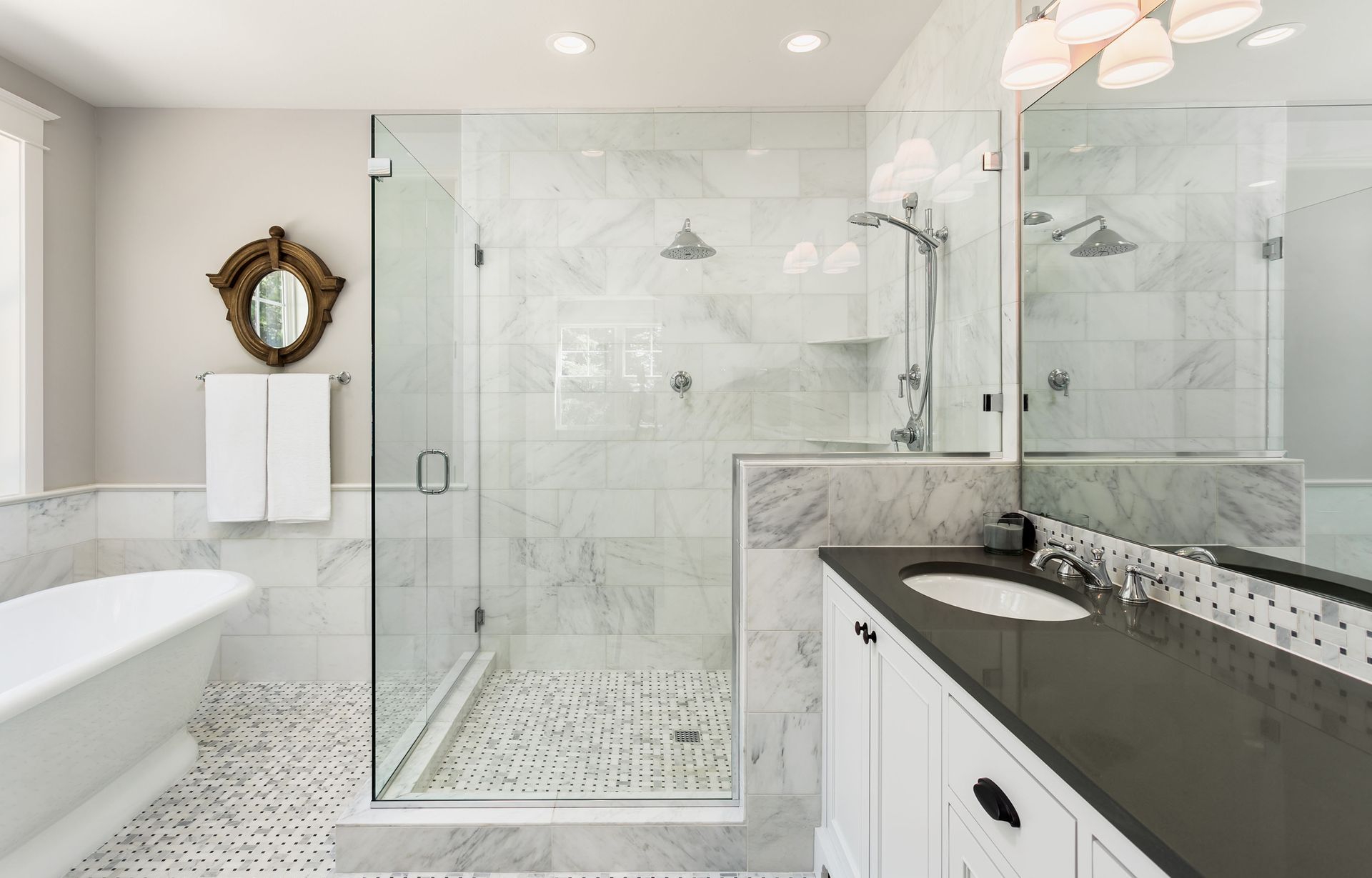 a bathroom with a bathtub, sink, shower and mirror