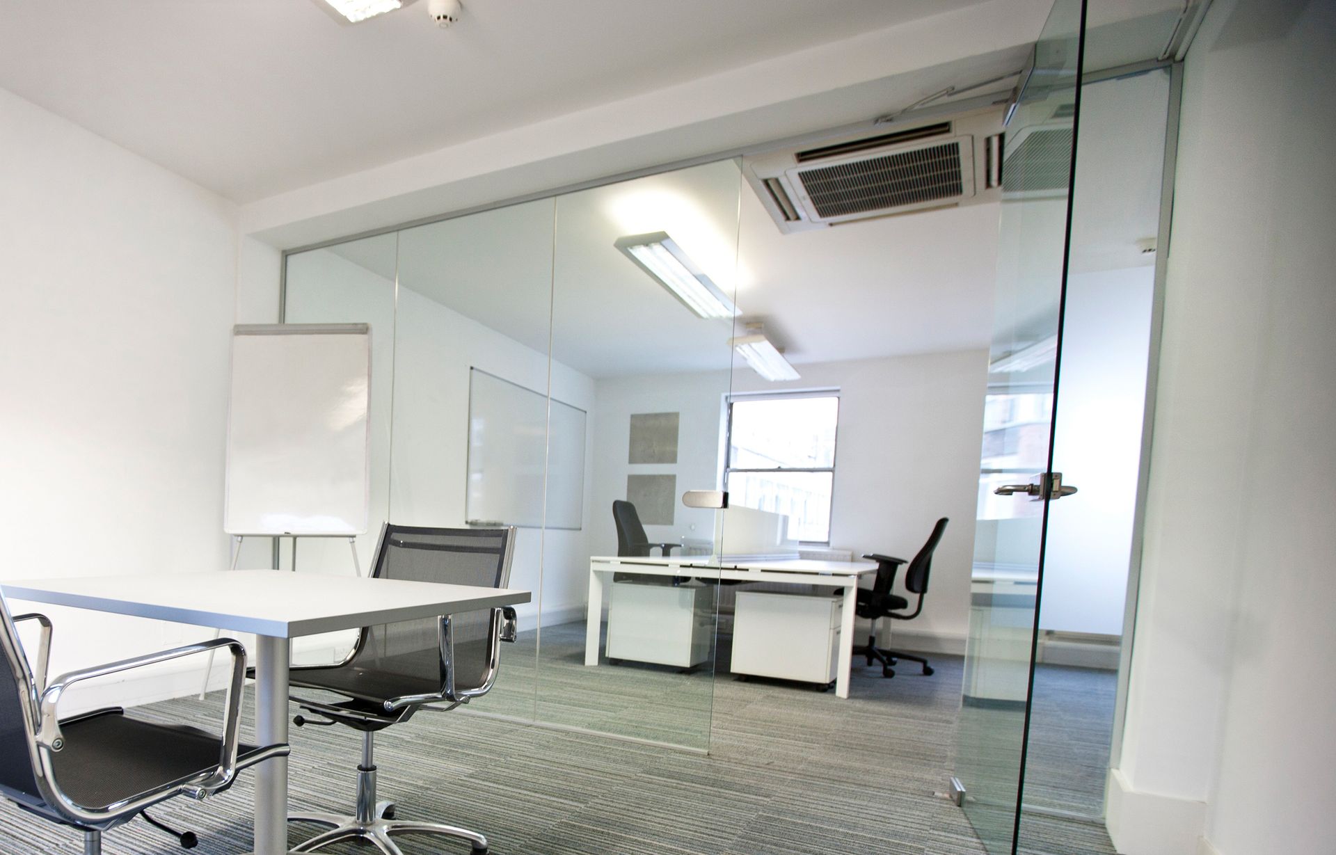 a conference room with a table and chairs in it
