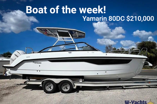 A white boat on water at sunset advertising the Suncoast Boat Show, happening April 17th-19th, 2026, featuring the W43.