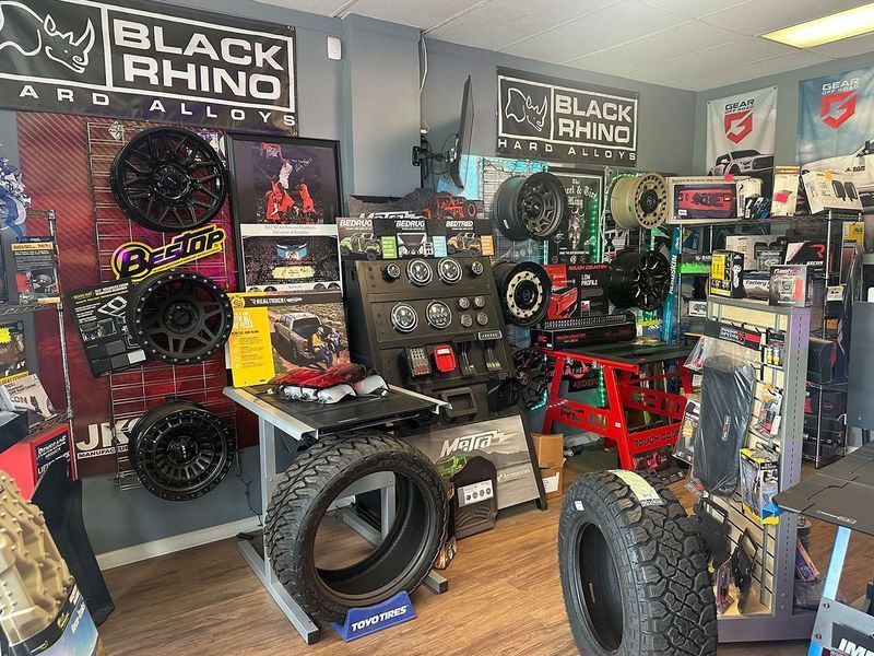 Black Rhino showroom with off-road wheels, tires, and automotive accessories on display