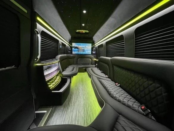 The inside of a limousine with a flat screen tv