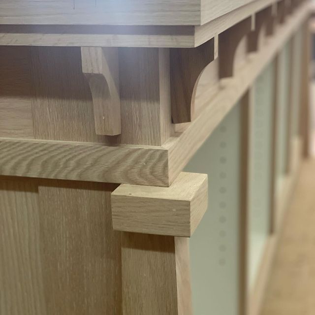 A close up of a wooden corner of a cabinet