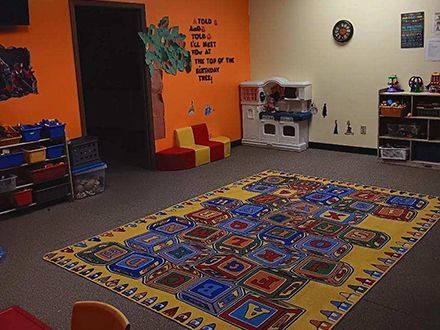 A room with a large rug on the floor