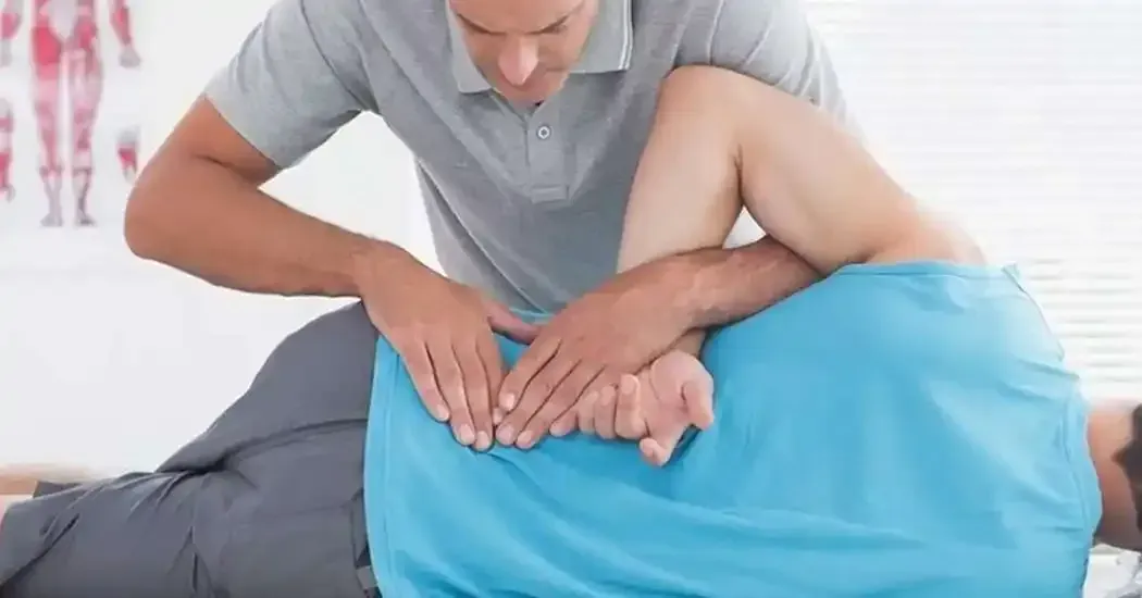 A person receiving a chiropractic adjustment