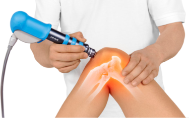 A person is getting a treatment on their knee with a machine.