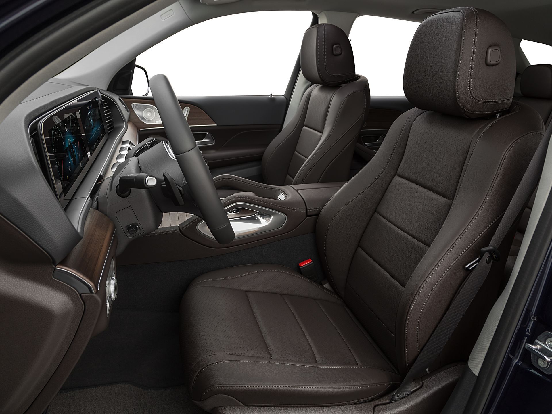 Interior of a car showing brown leather front seats, a steering wheel, and a digital dashboard display.