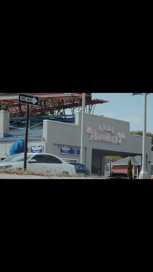 A storefront with a white façade and a sign reading 