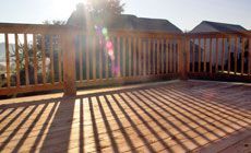 Large wooden deck with wooden railing around it
