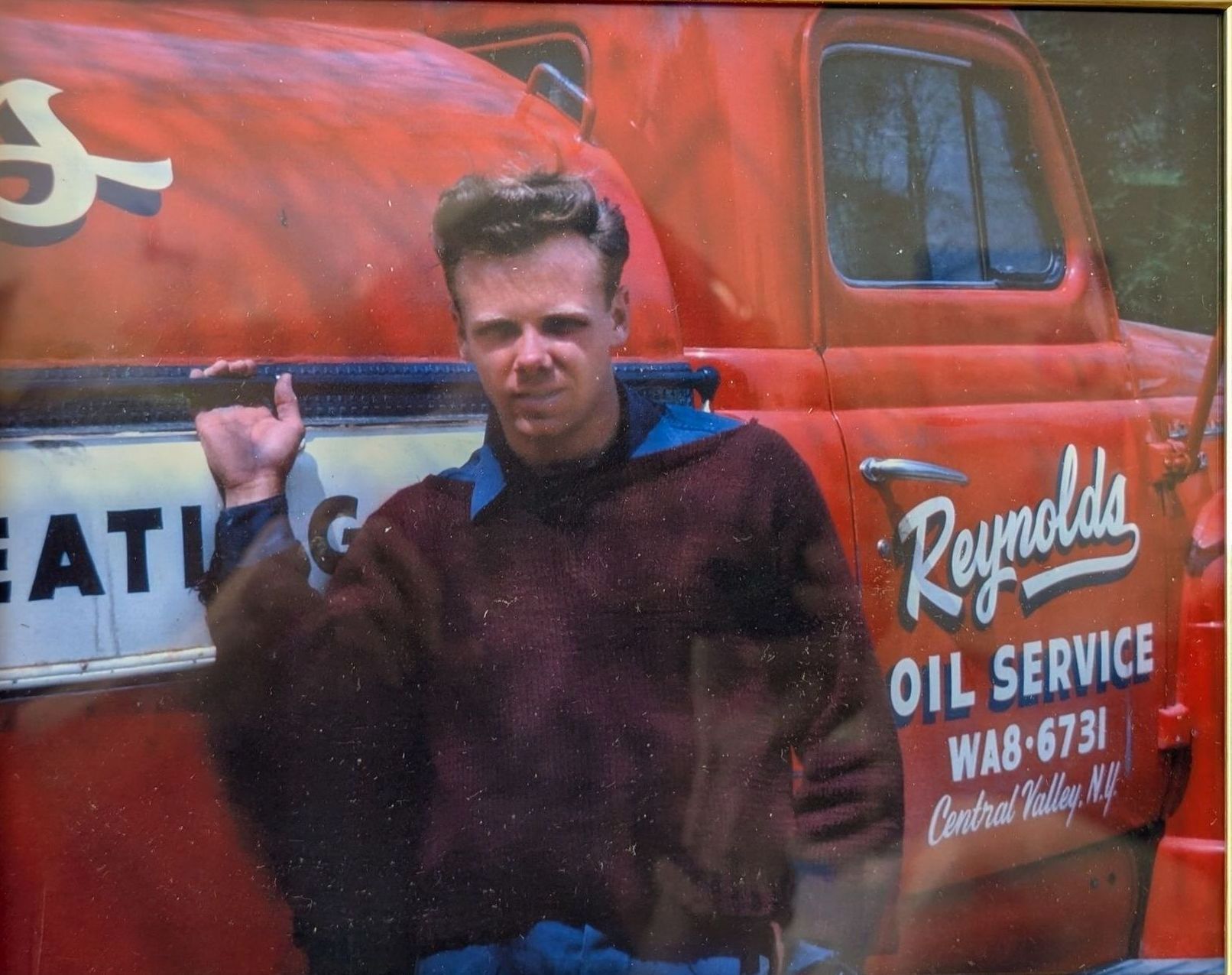 man in front red truck