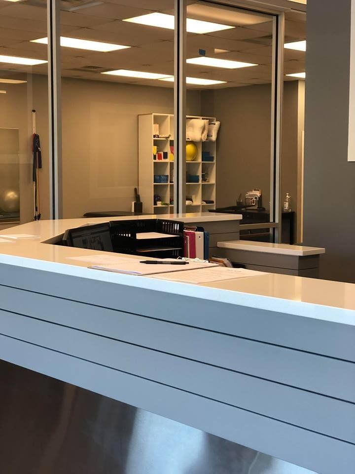 A reception desk in a building with a large window