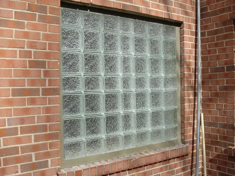 Brick building with a window made of glass blocks.