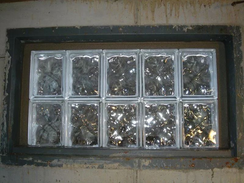 Clear glass block window in a concrete basement wall.