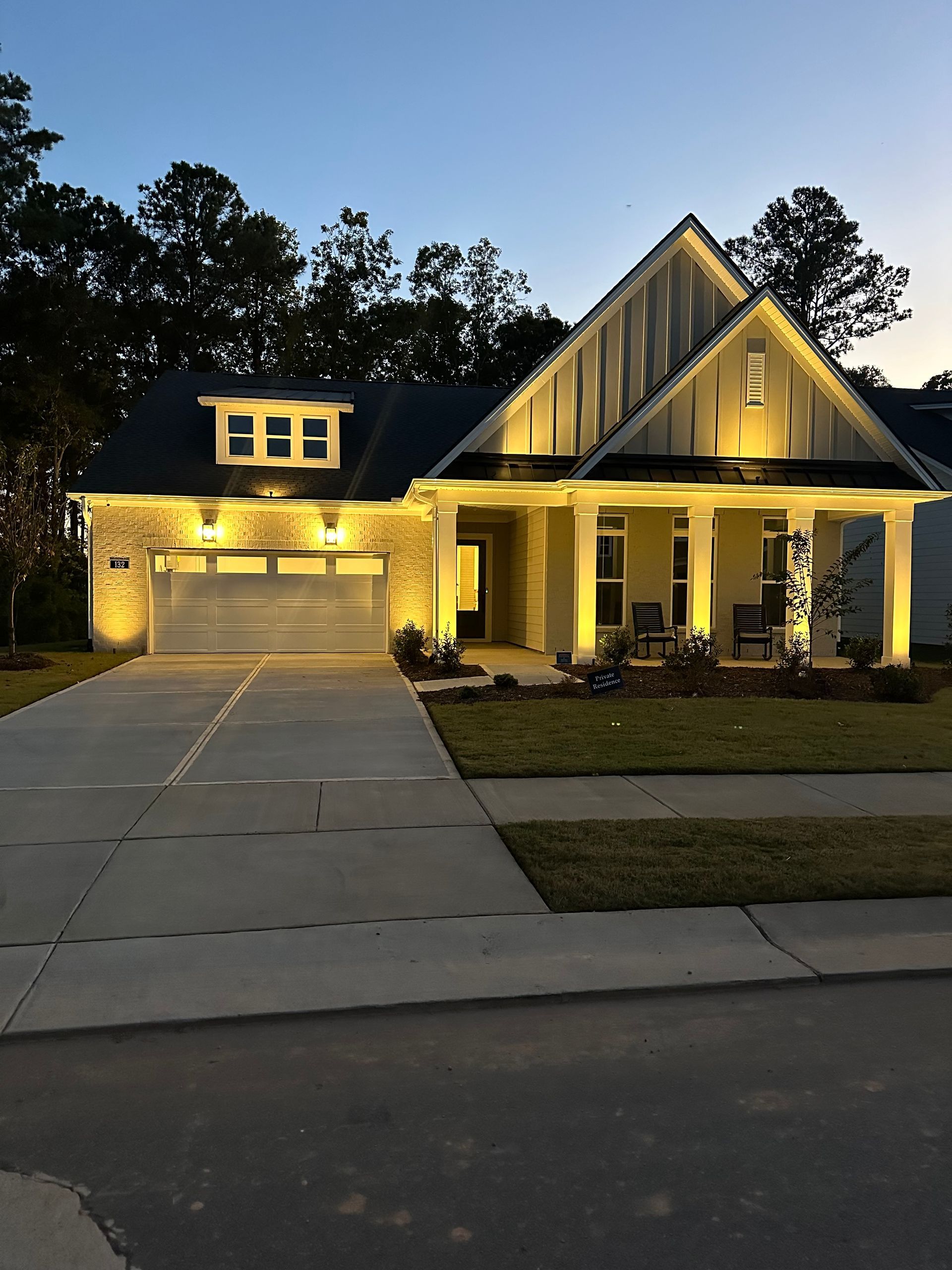 The front of a house is lit up at night