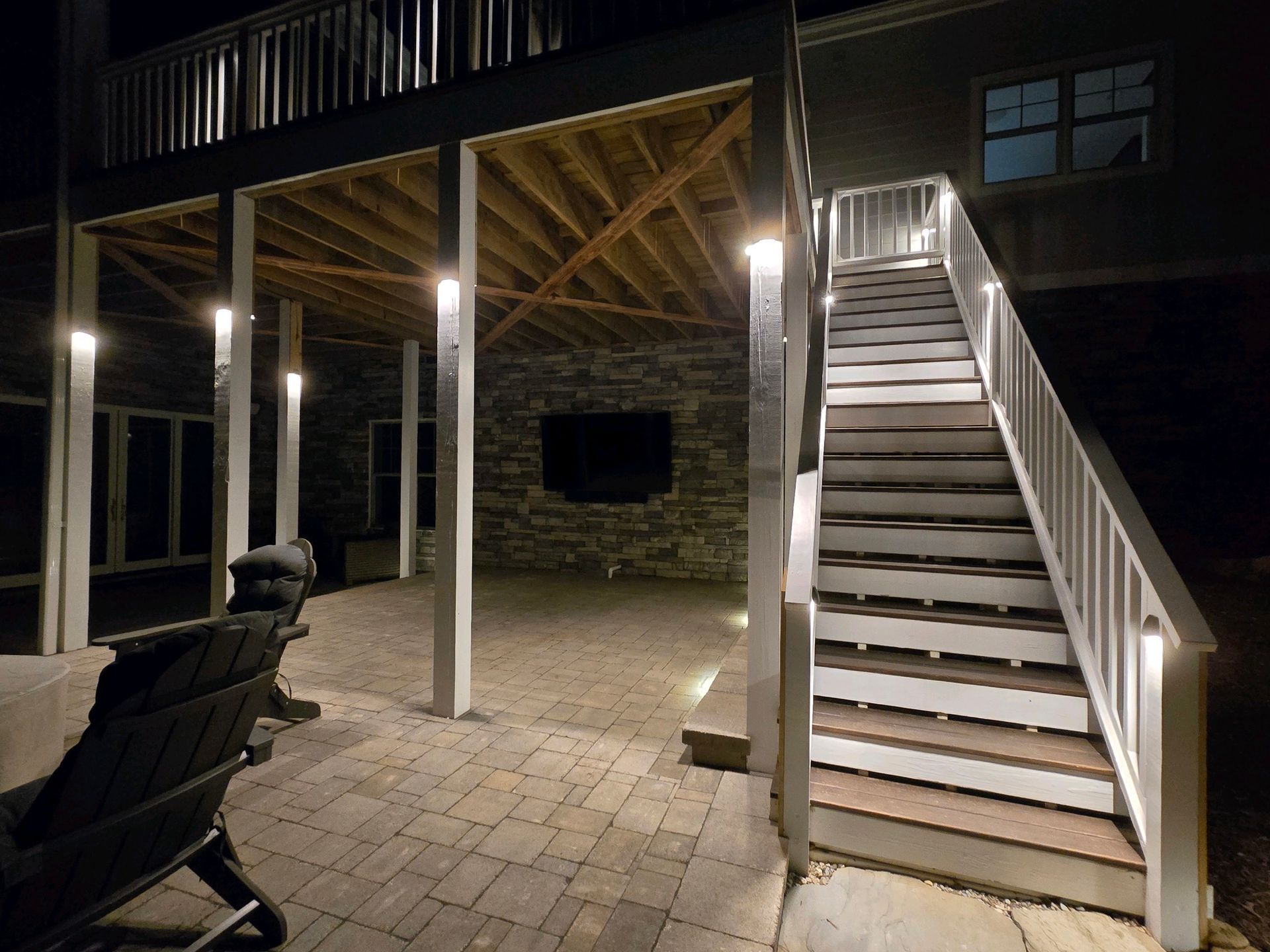 A house with stairs that are lit up at night