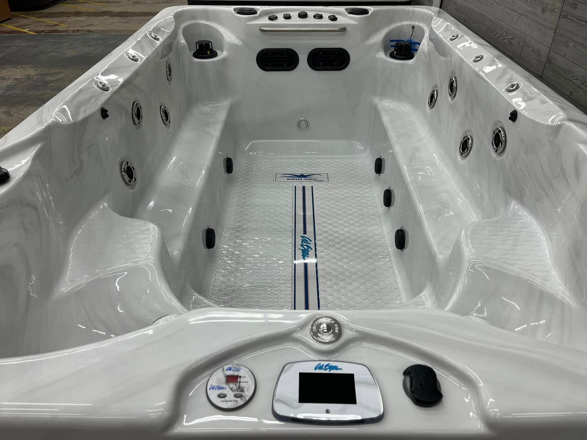 White hot tub spa interior with seats, jets, and a control panel at the front