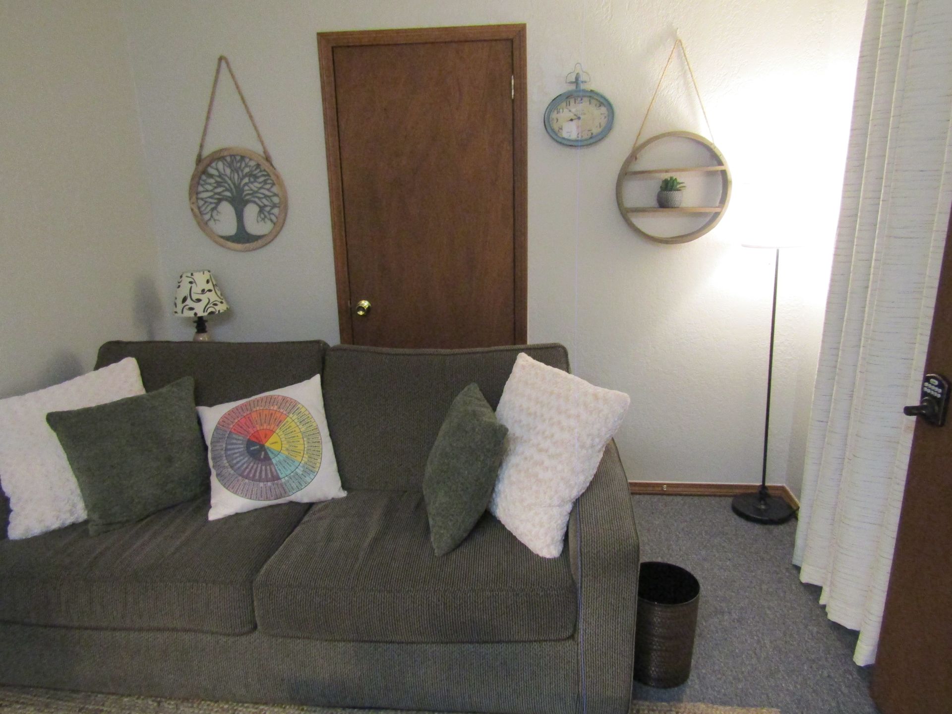 A kitchen with wooden cabinets, a sink, a microwave, and a dishwasher.