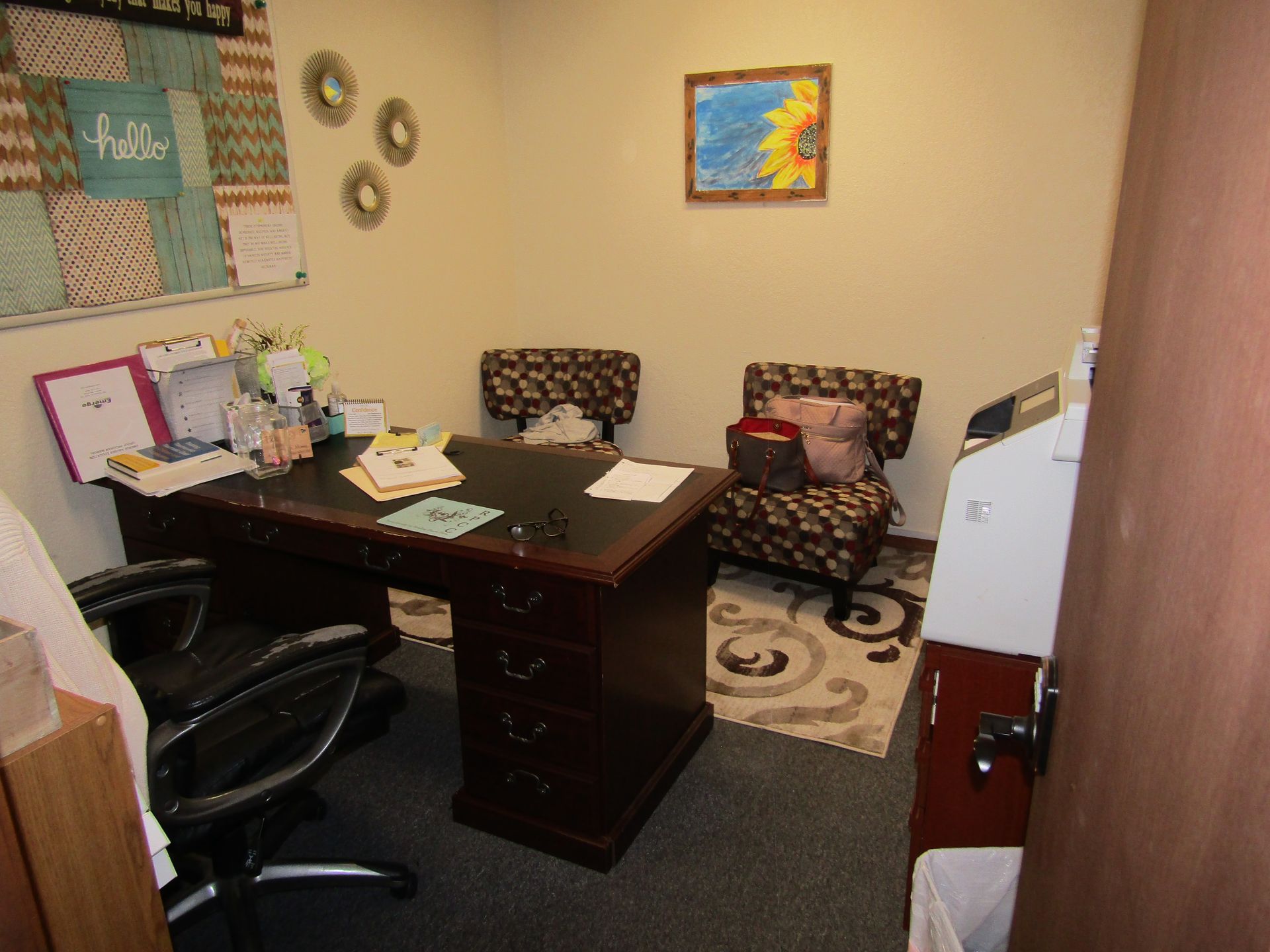 A waiting room with chairs and a tv on the wall