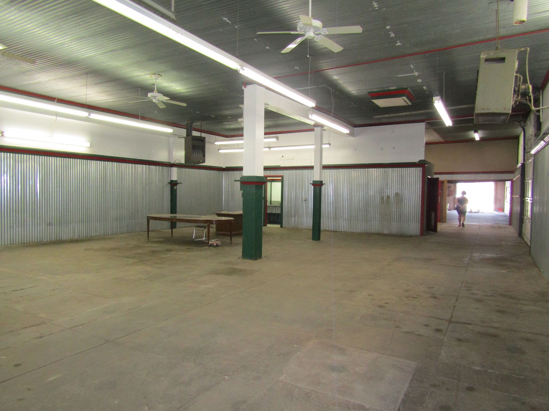 An empty room with a table and a ceiling fan