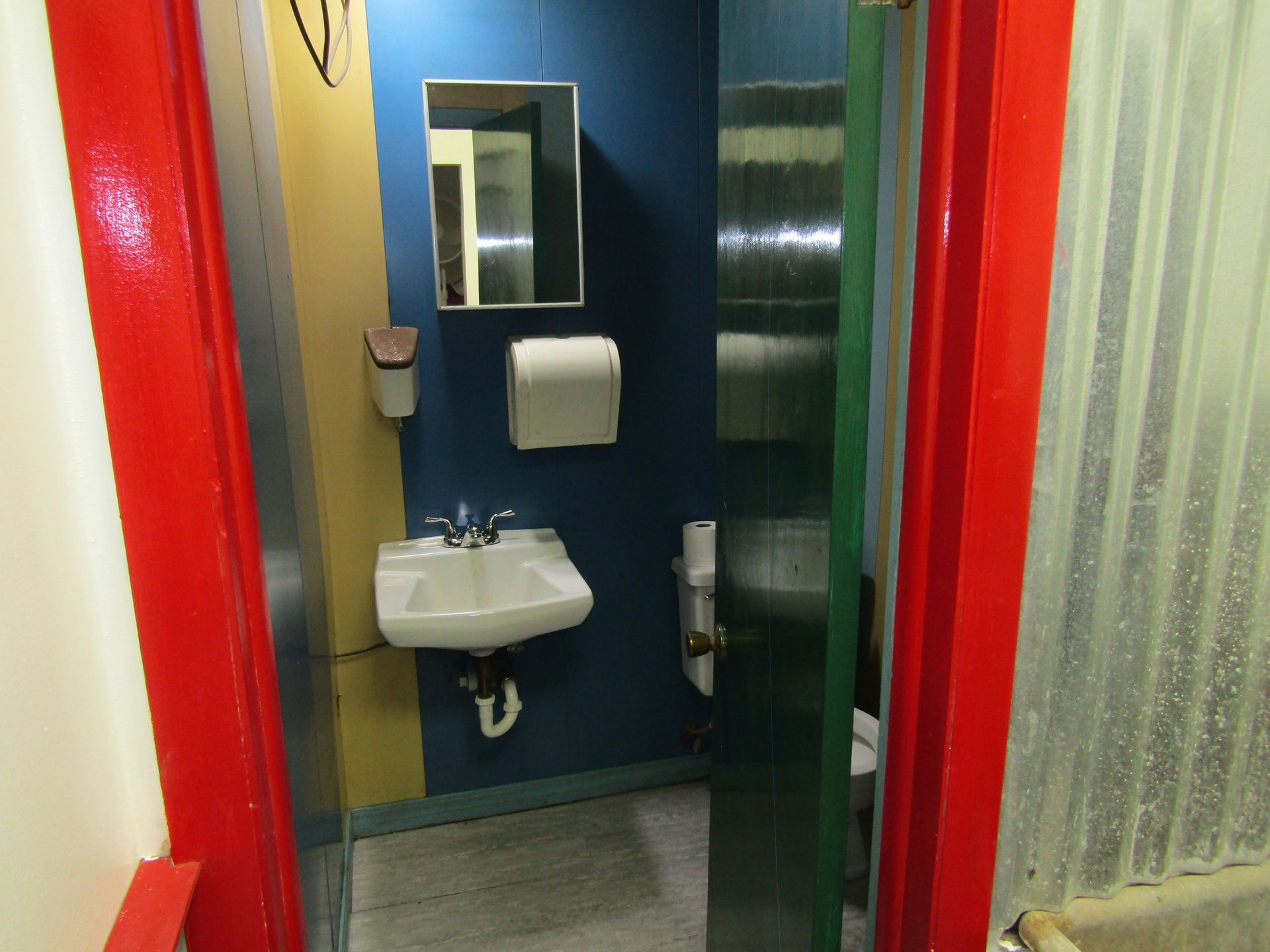 A bathroom with a sink a mirror and a toilet