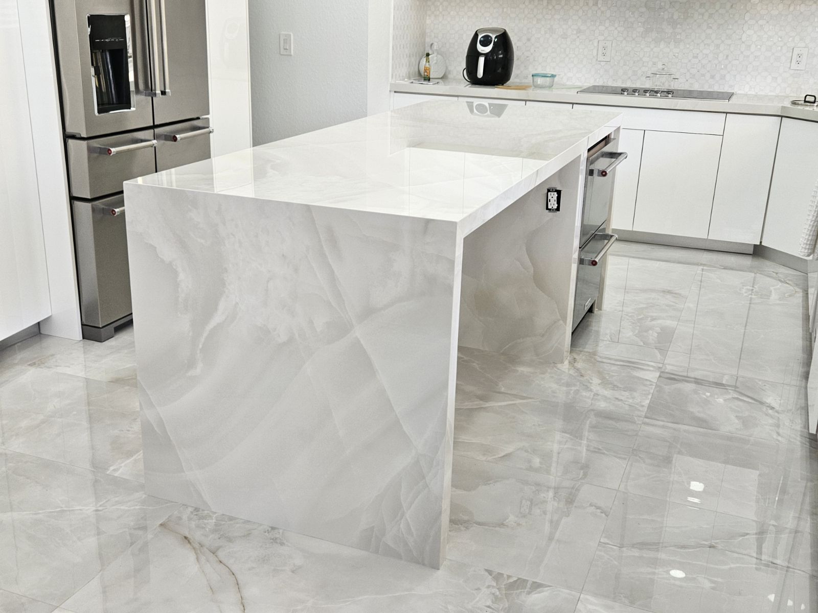 A kitchen with a large island in the middle of it.