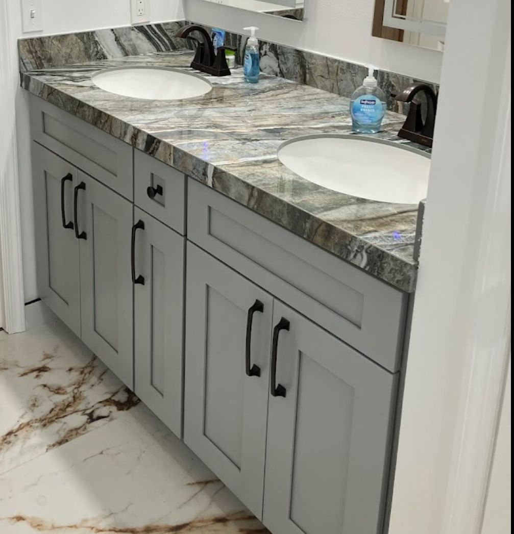 A bathroom with two sinks and a soap dispenser.