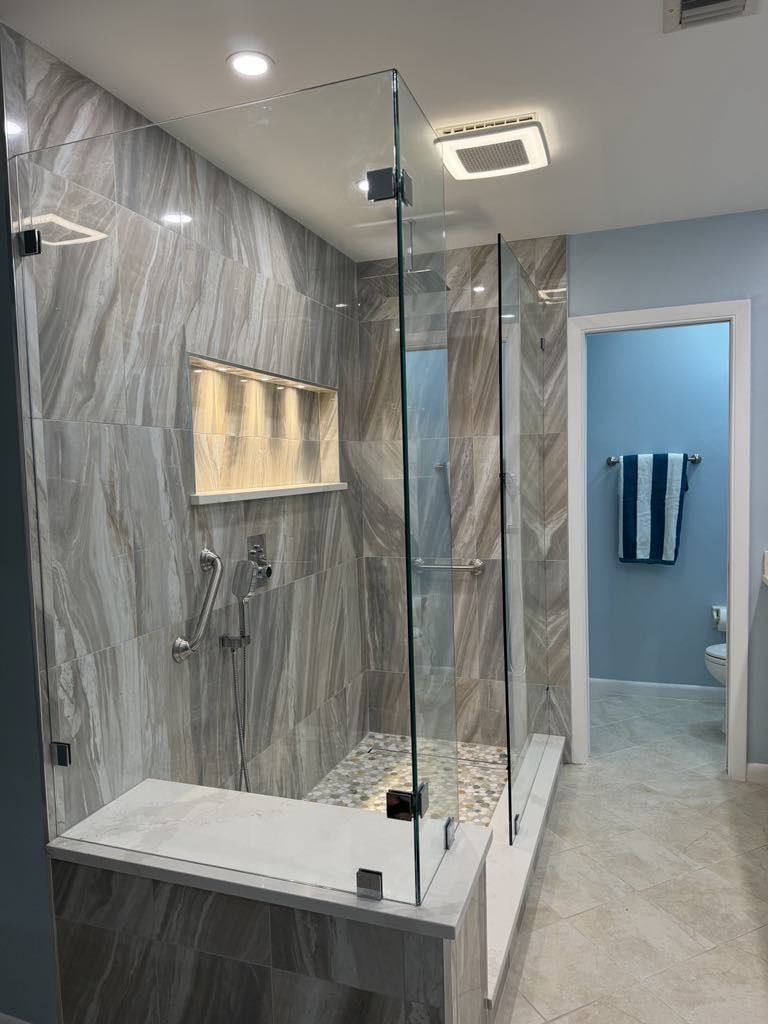 A bathroom with a walk-in shower and a bathtub.