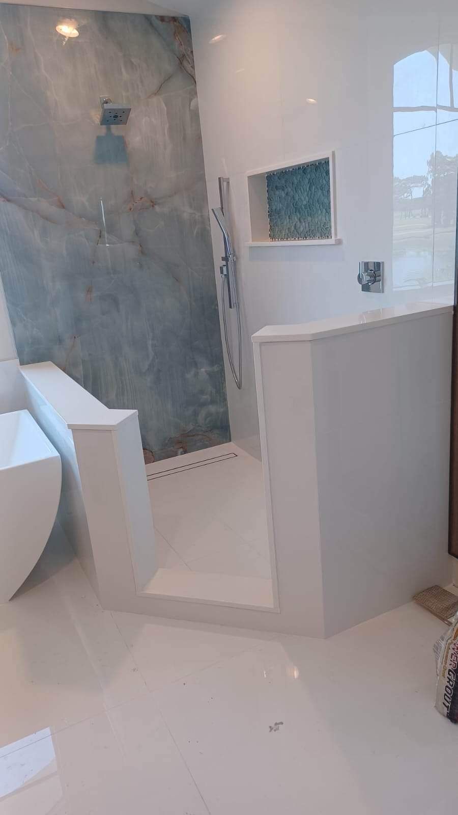 A bathroom with a walk in shower and a bathtub.