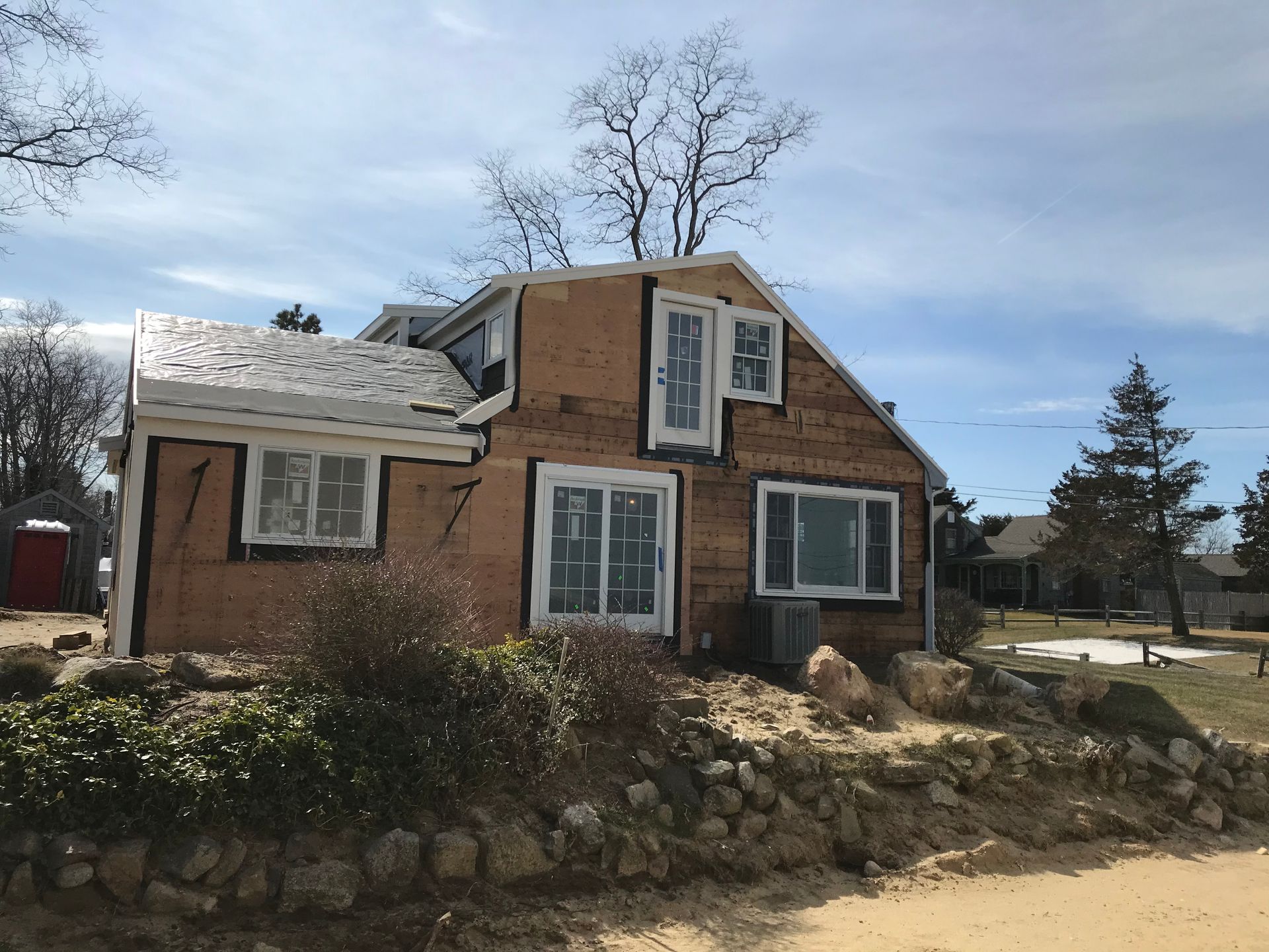 A house with a lot of windows is being remodeled