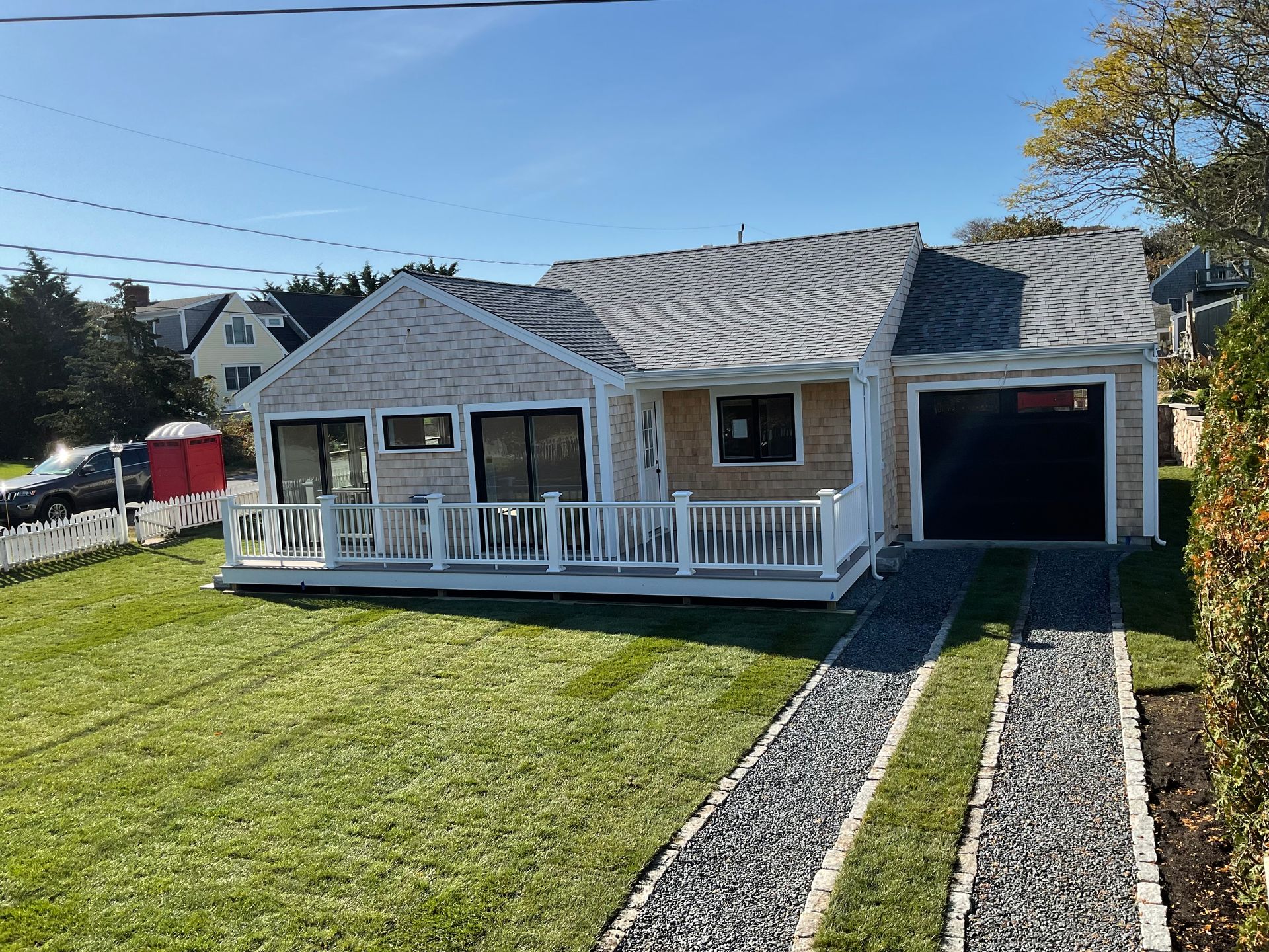 A small house with a porch and a garage