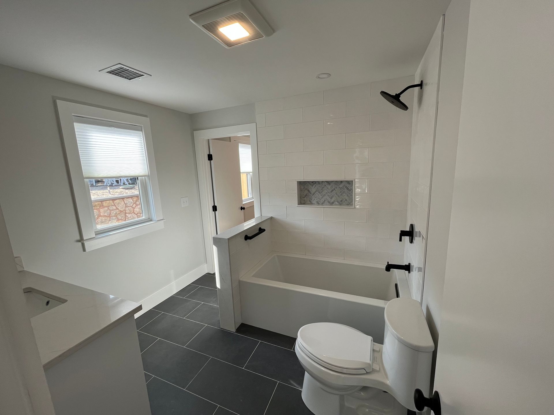 A bathroom with a toilet, bathtub, and shower