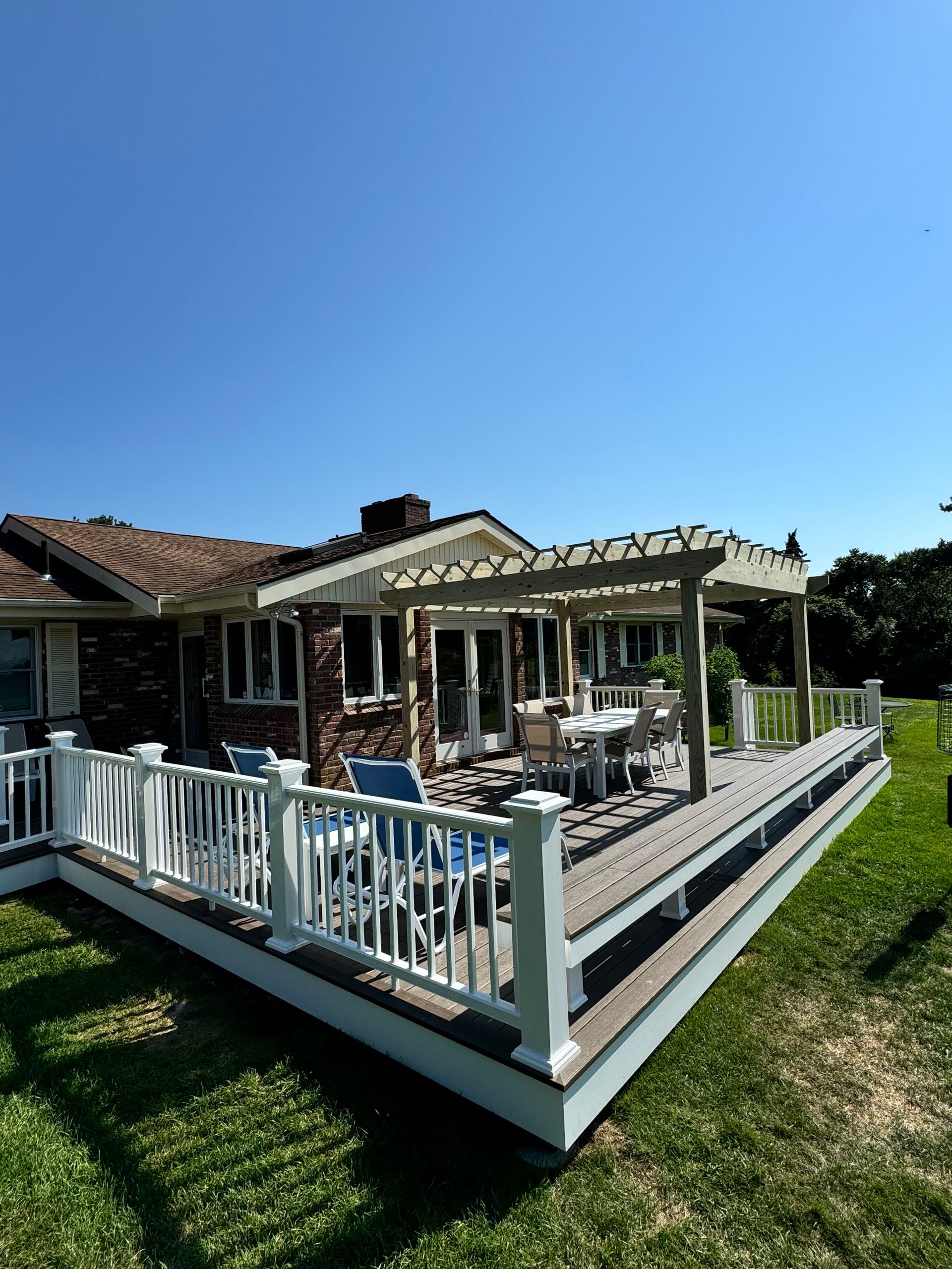 A house with a large deck and a pergola