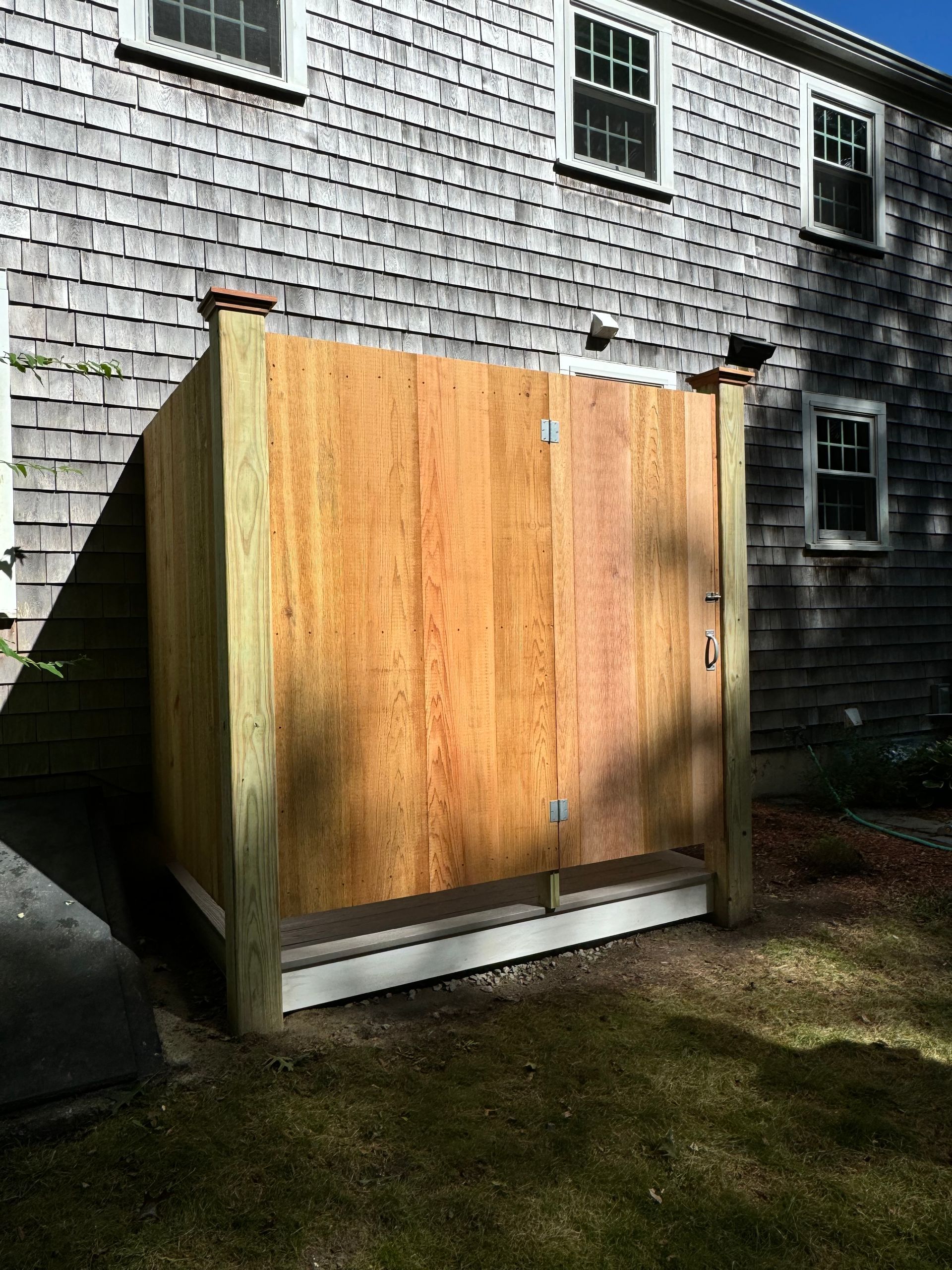 A wooden fence is sitting in front of a house
