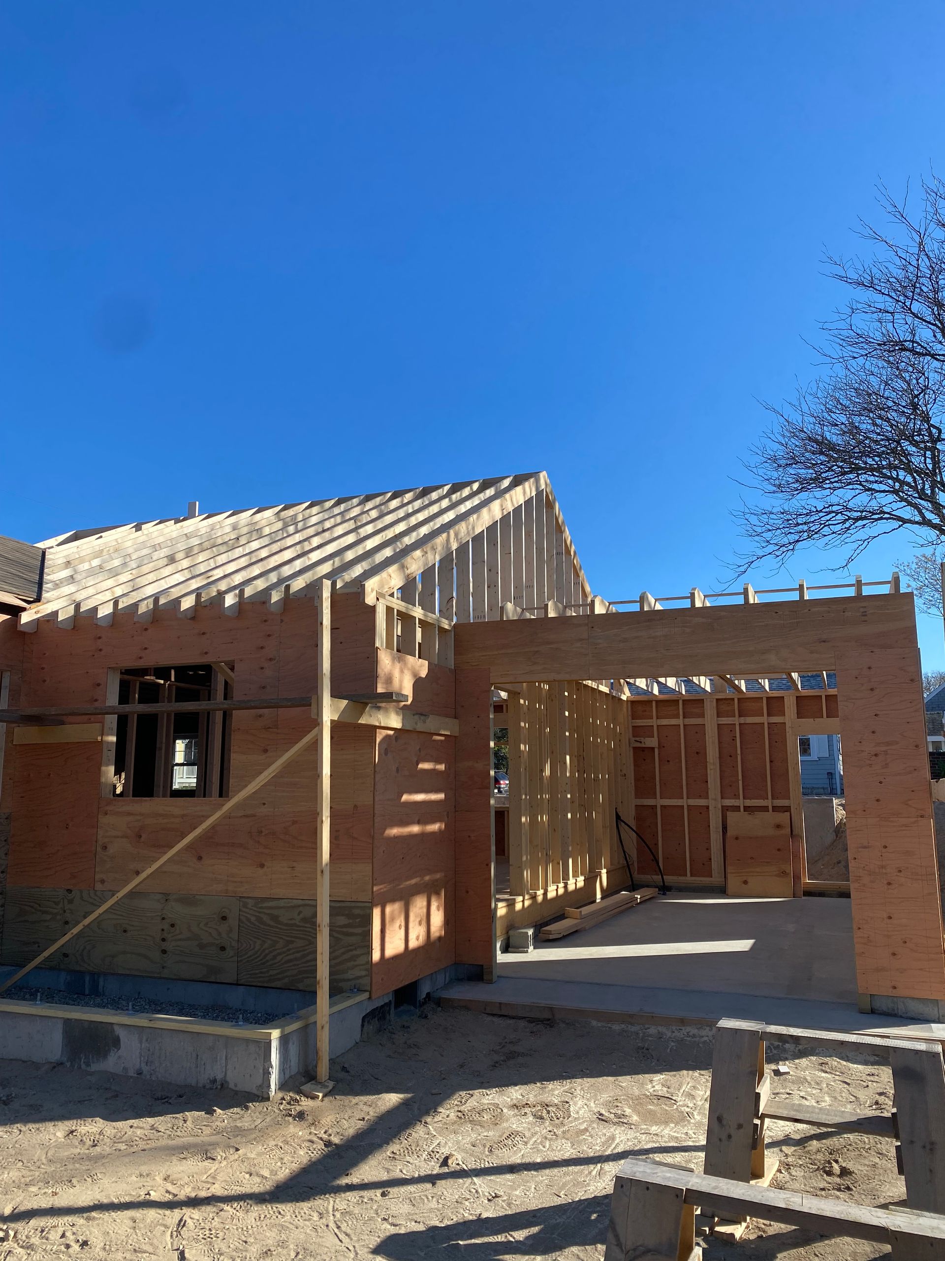 A house under construction with a blue sky in the background