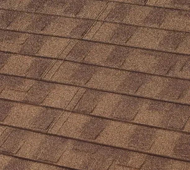 Brown asphalt roof shingles, angled view.