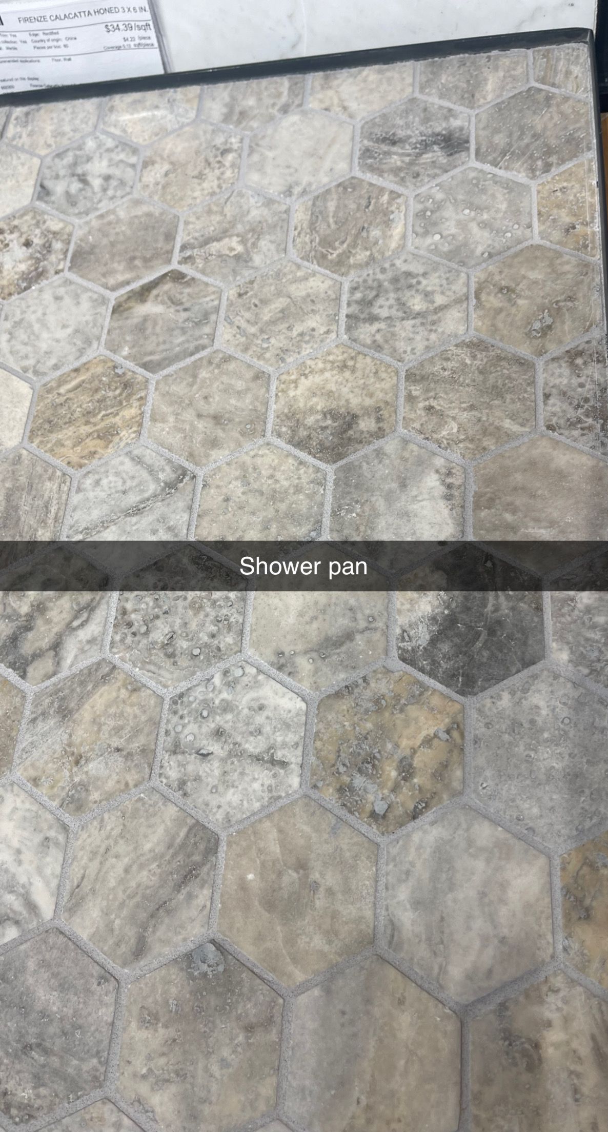 Stone-paved outdoor ground with irregular gray hexagonal stones and a dark border line near the top.