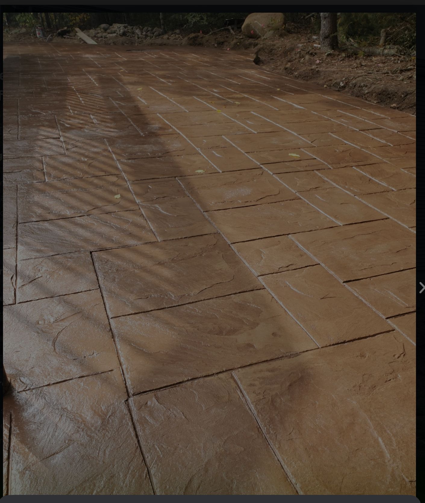 Wet tiled walkway with muddy water streaks and footprints outdoors