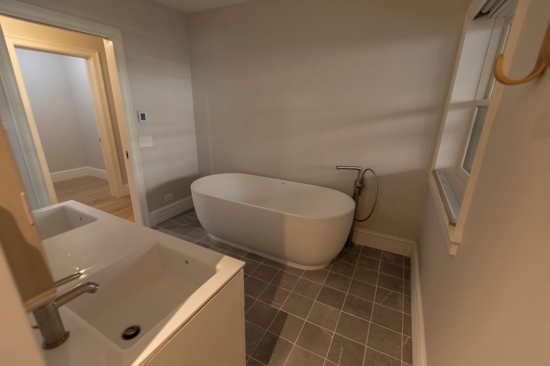 Modern bathroom with freestanding tub, walk-in shower, and tiled floor