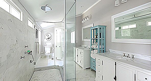 Spacious, light-filled bathroom with glass shower, white vanities, and blue accent cabinet.