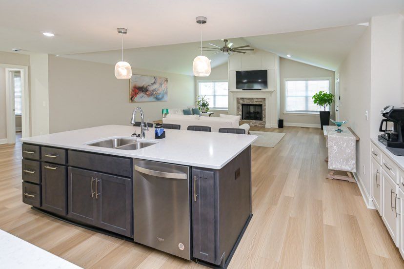A kitchen with a large island and stainless steel appliances.