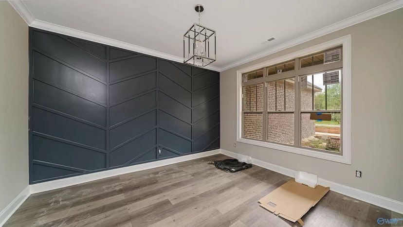 An empty bedroom with a large window.