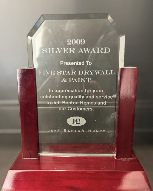 A silver award presented to five star drywall and paint